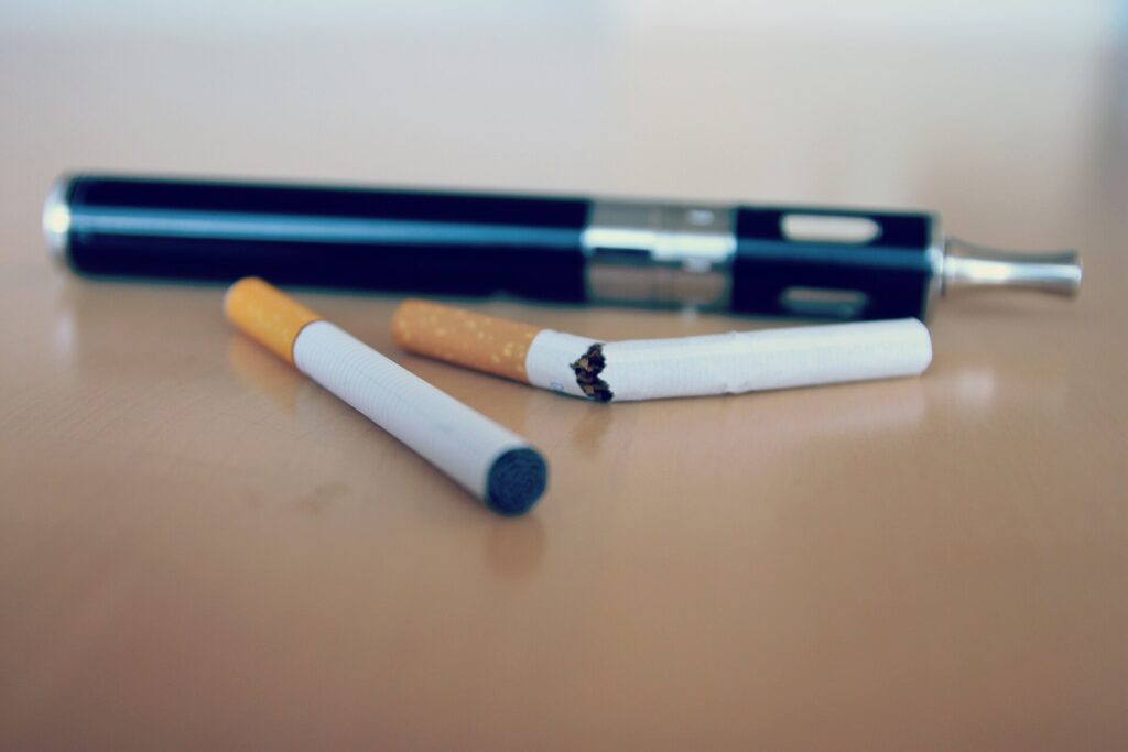 A question mark graphic over a stylised lung illustration and vape device